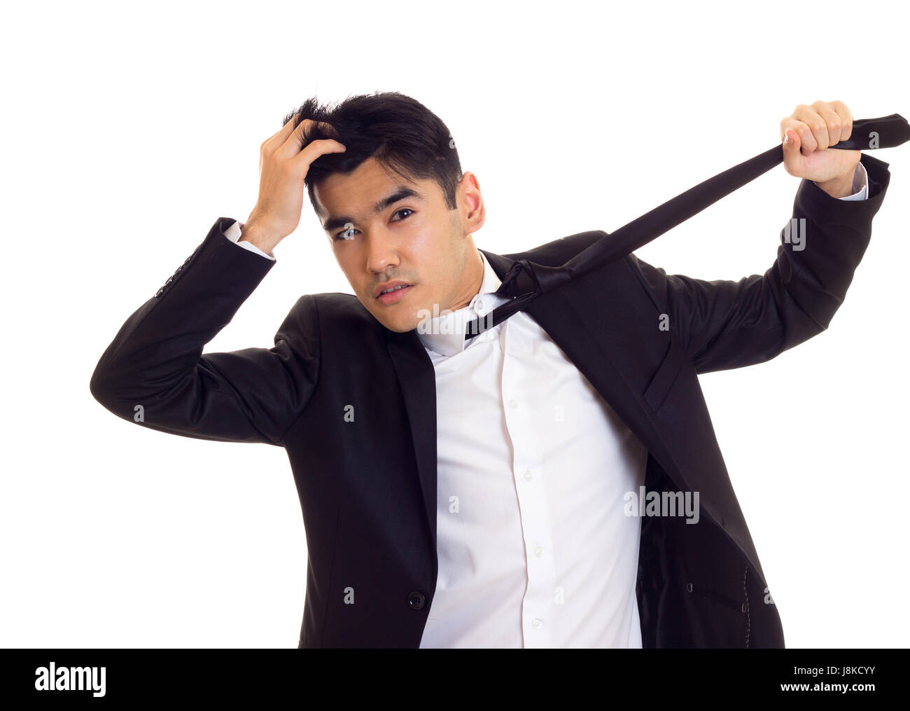 Young man in suit fixing his tie Stock Photo - Alamy