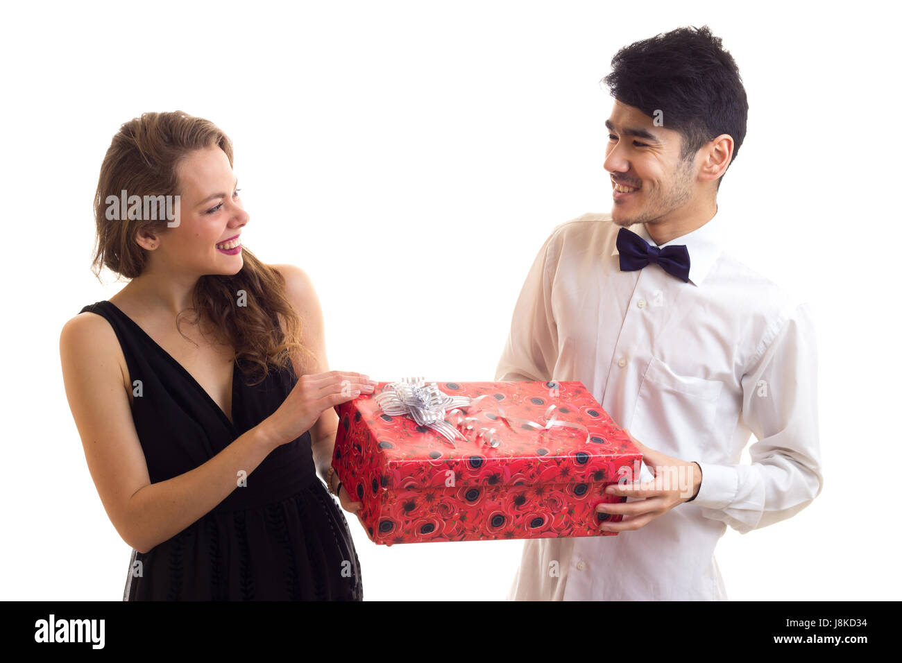 Young couple holding a present Stock Photo - Alamy
