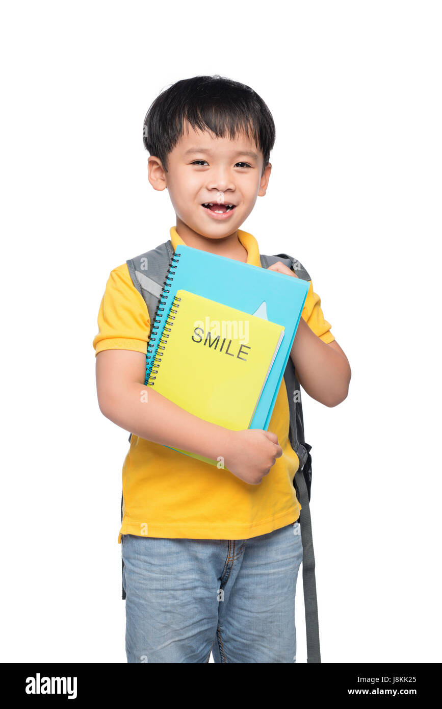 Portrait of cute smiling boy with backpack and colorful books ...