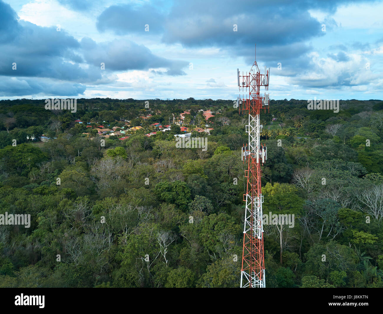 Mobile tower antenna aerial view on small town background Stock Photo
