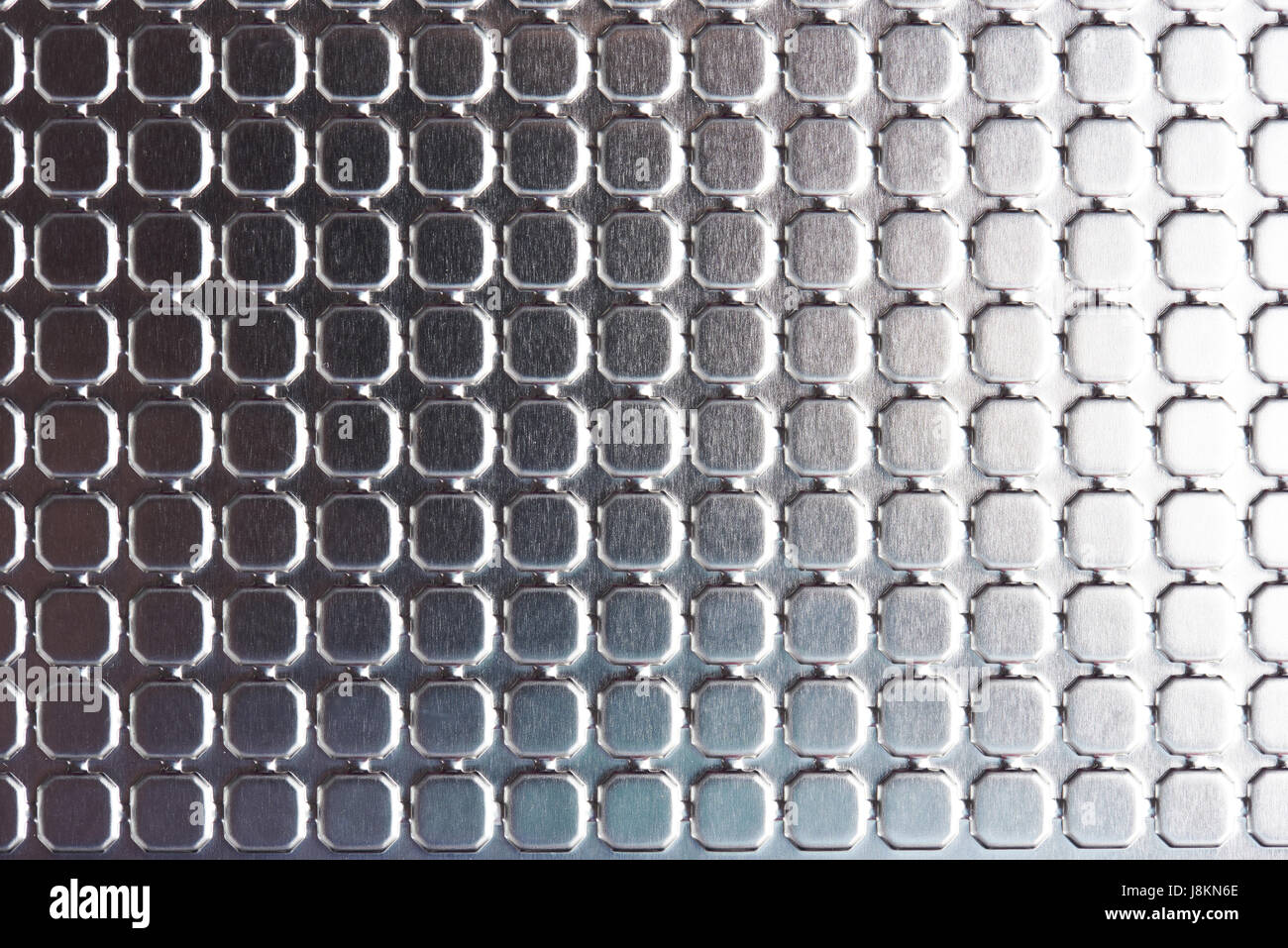 Squares on shiny metal surface close-up. Tiles on metallic surface Stock Photo