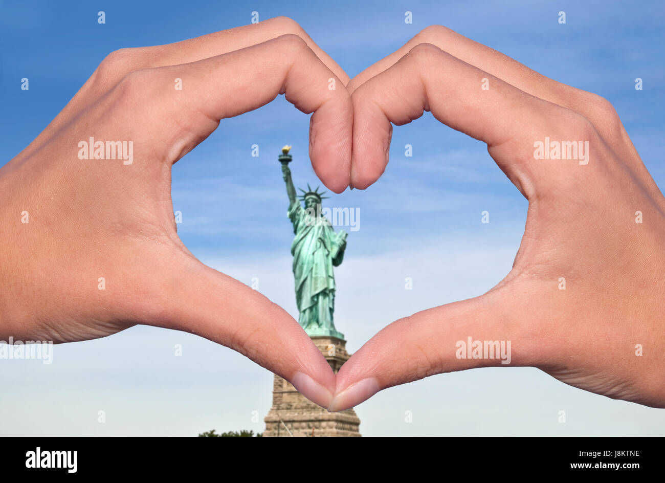 Statue of liberty and hands forming a heart, New York love and travel concept Stock Photo