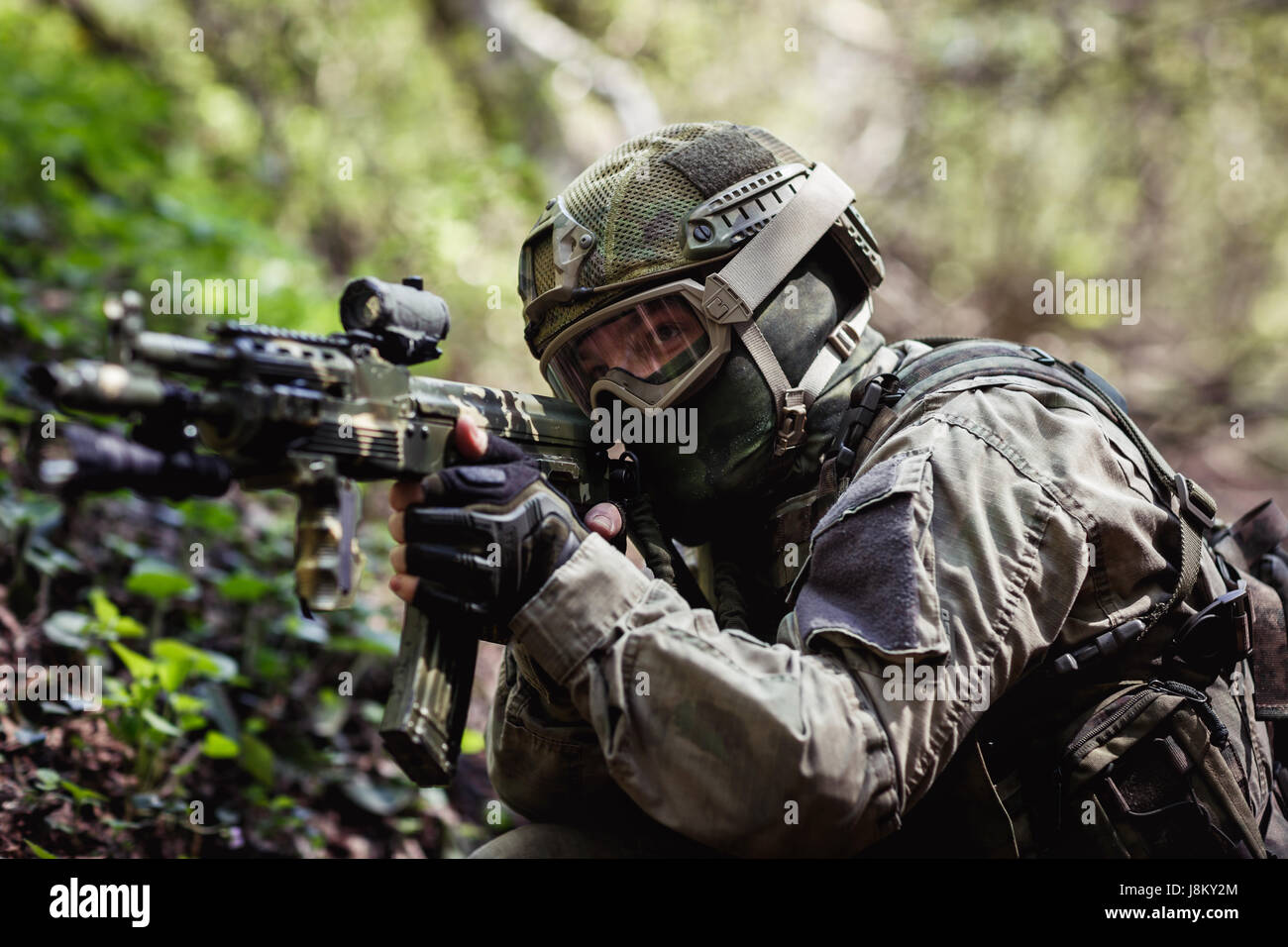Military man aiming in forest Stock Photo
