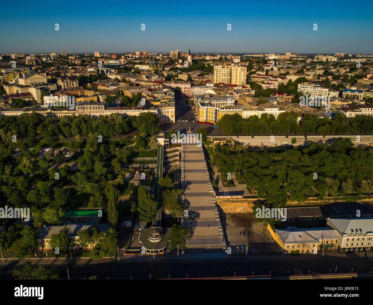 Elevated drone image of the Potemkin Stairs and Prymorski Boulevard with Istanbul Pakr and the Odessa Skyline behind. Taken at sunrise on a summer mor Stock Photo