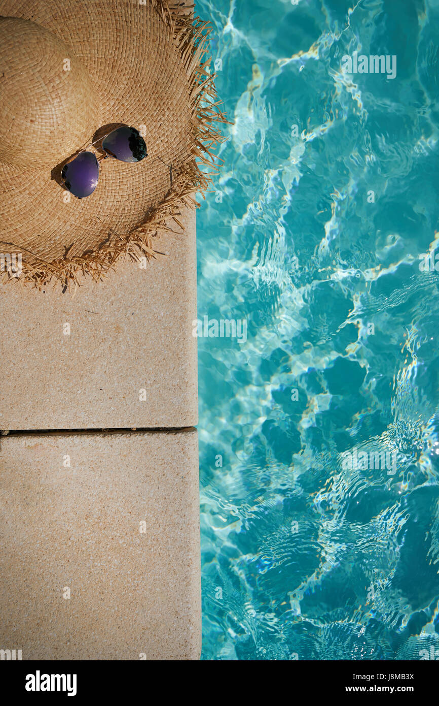 summer hat and sunglasses near the swimming pool Stock Photo - Alamy
