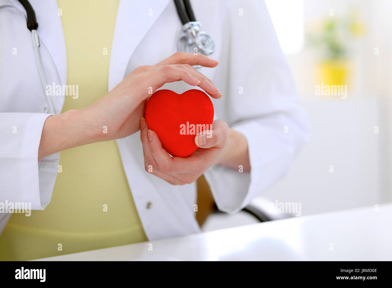 Female doctor with stethoscope holding heart Stock Photo - Alamy