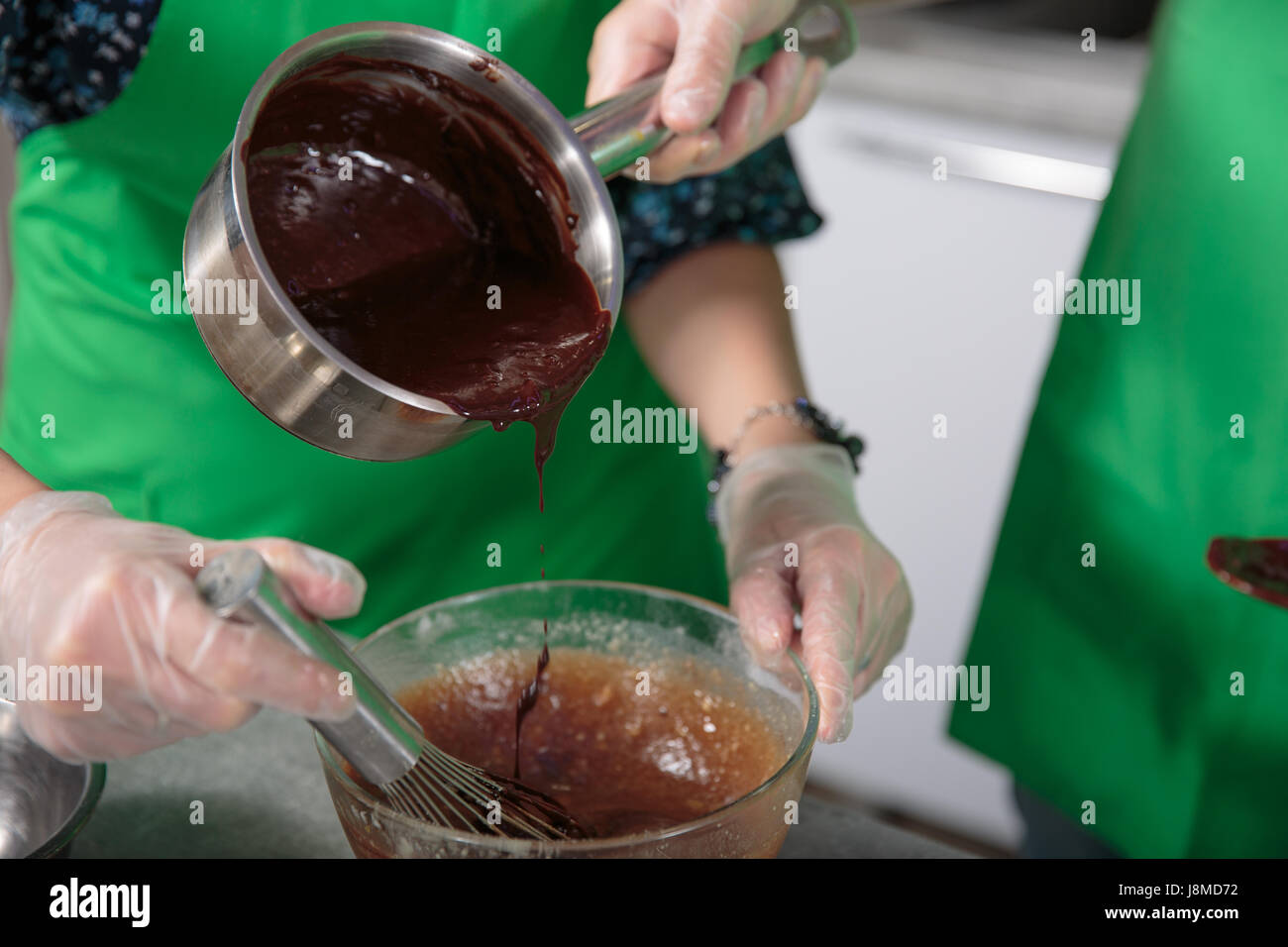 Preparing chocolate sauce for a chocolate cake Stock Photo