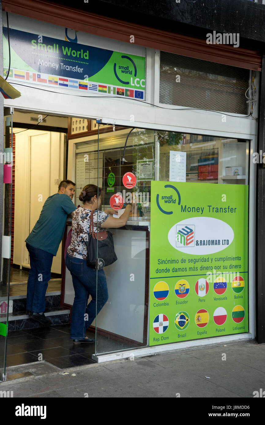 Latin American immigrants at a the office of a money transfer service at  the old Elephant and Castle shooping centre, due to be demolished for  re-development of the area,Southwark,London.UK Stock Photo -