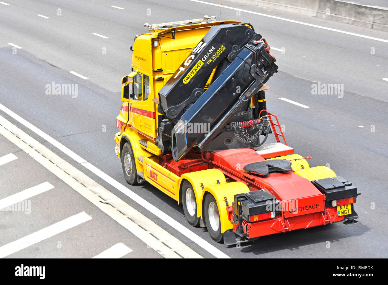 Articulated hgv logistics truck uk lorry without trailer driving on Essex English UK m25 motorway with Outreach Palefinger PK 100002 crane behind cab Stock Photo