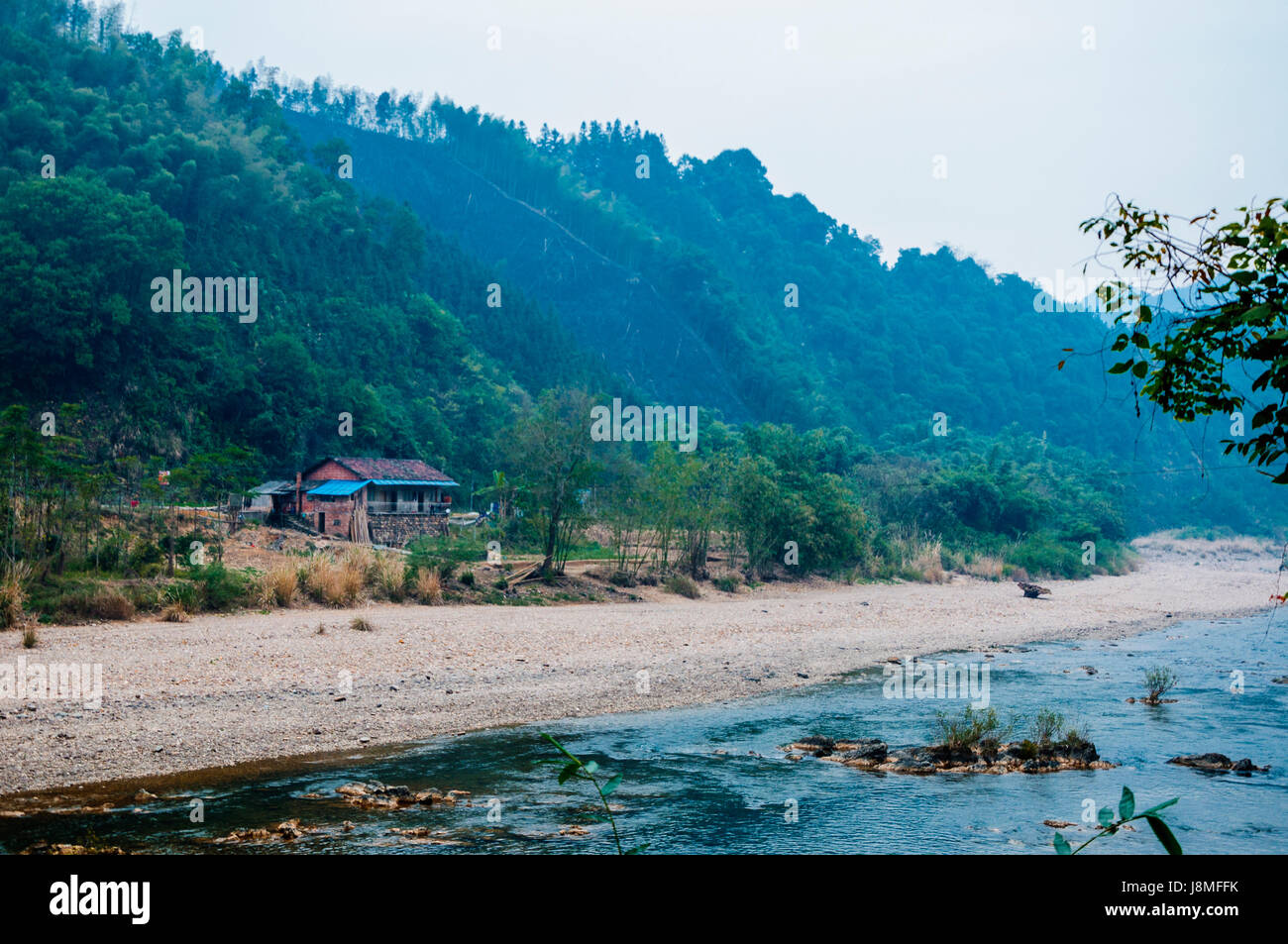 Mountains and river scenery in mist Stock Photo