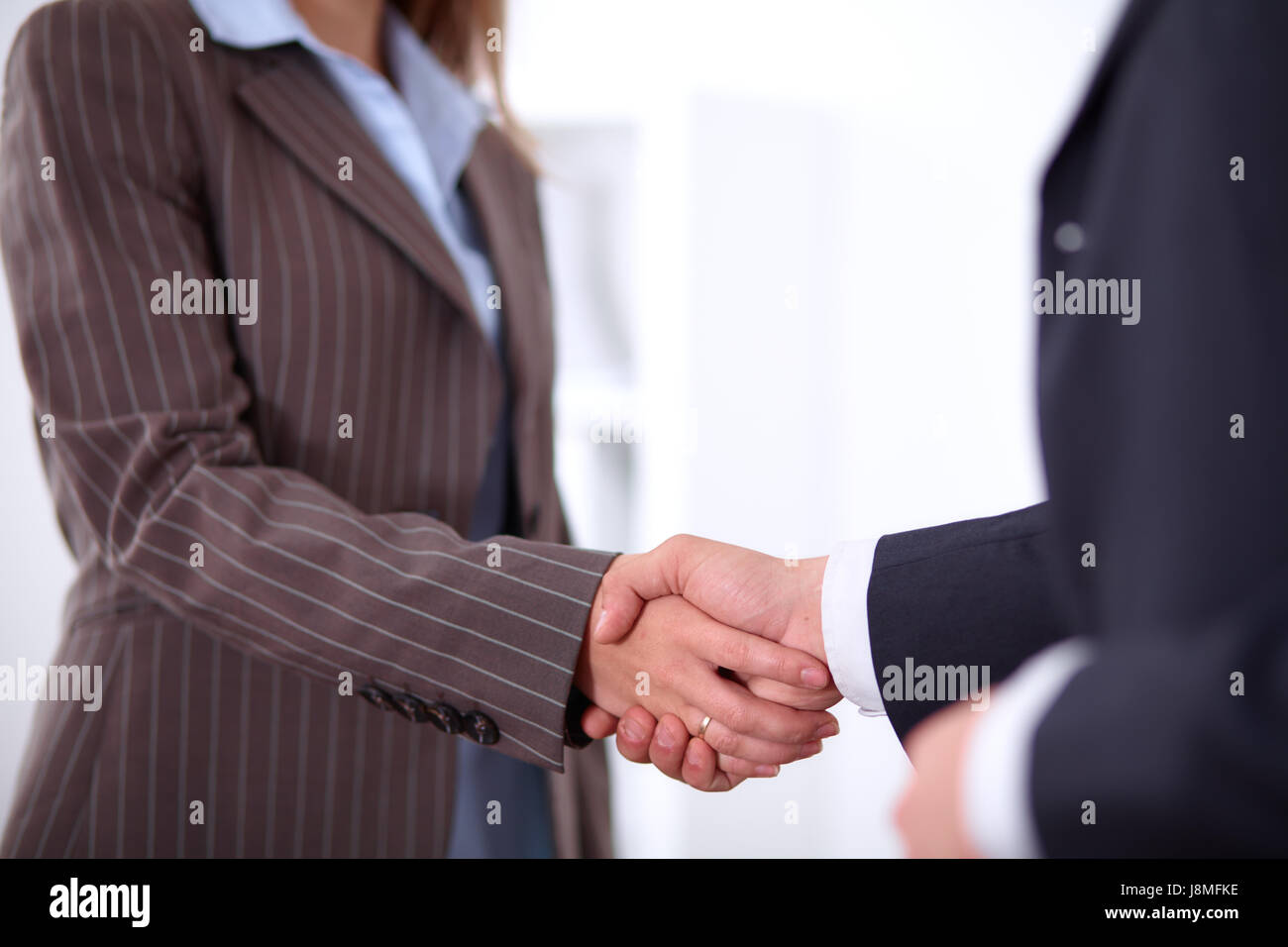 Business people shaking hands, standing Stock Photo