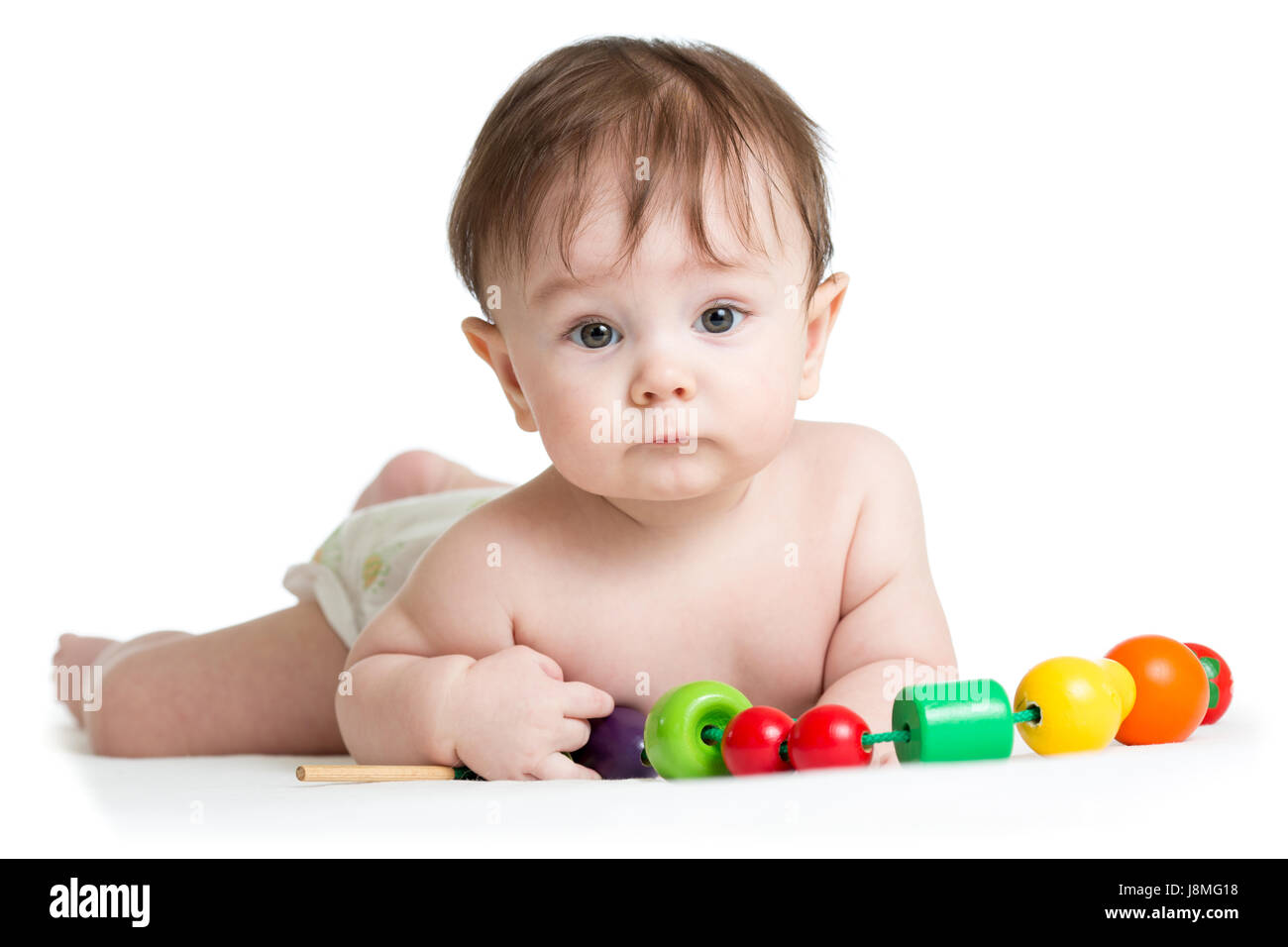 Portrait of cute baby boy with developmental wooden toys. Stock Photo