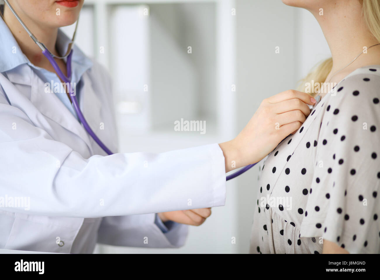doctor examines a patient with a stethoscope Stock Photo - Alamy