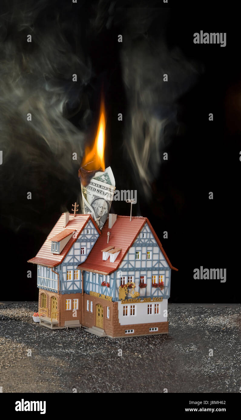 Burning hotel, burning Dollar note. Toy model. Stock Photo