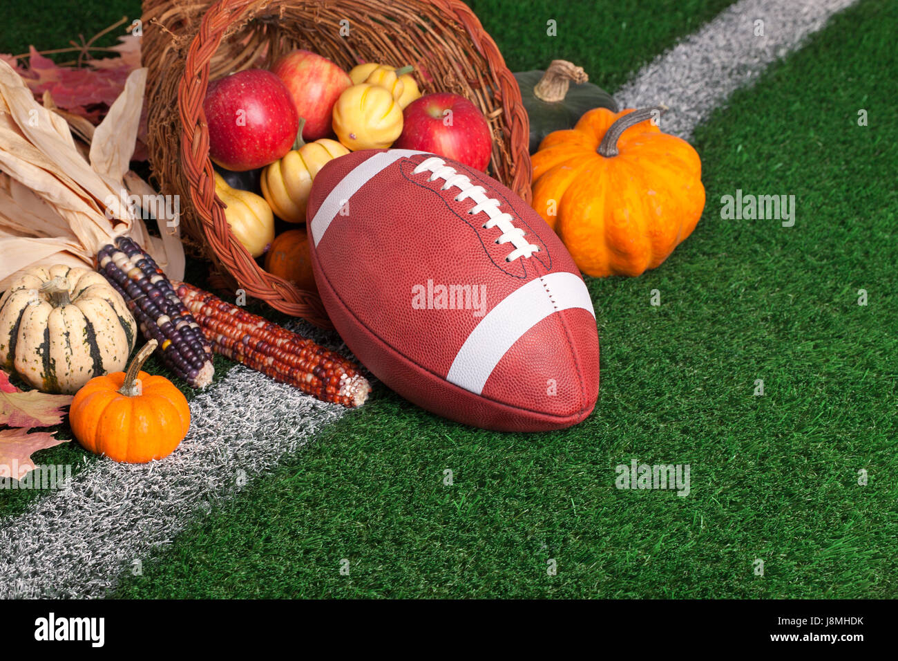 College style football in a cornucopia with seasonal produce Stock Photo