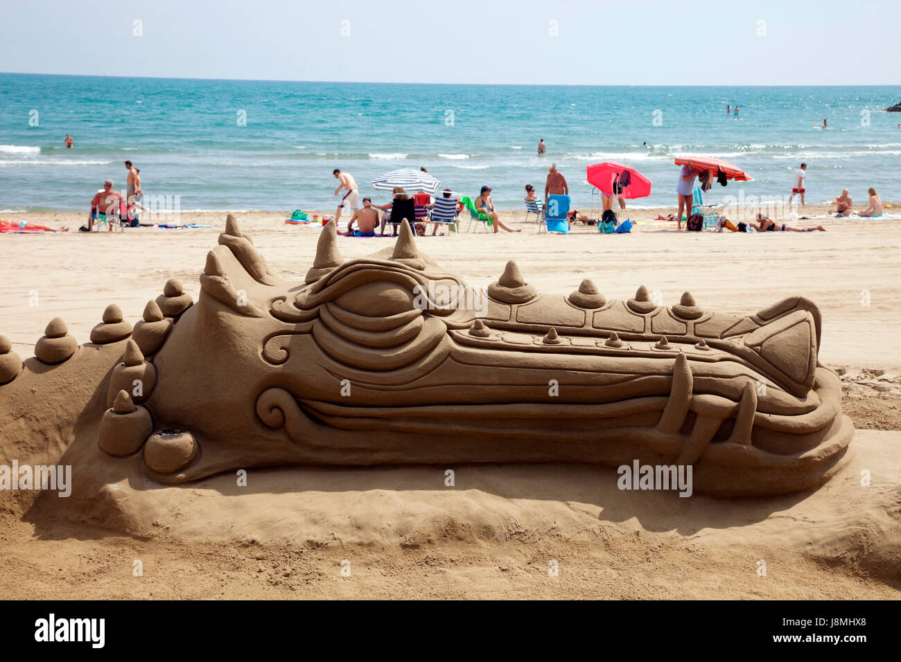 Sea monster sand sculpture on Peniscola Beach Stock Photo