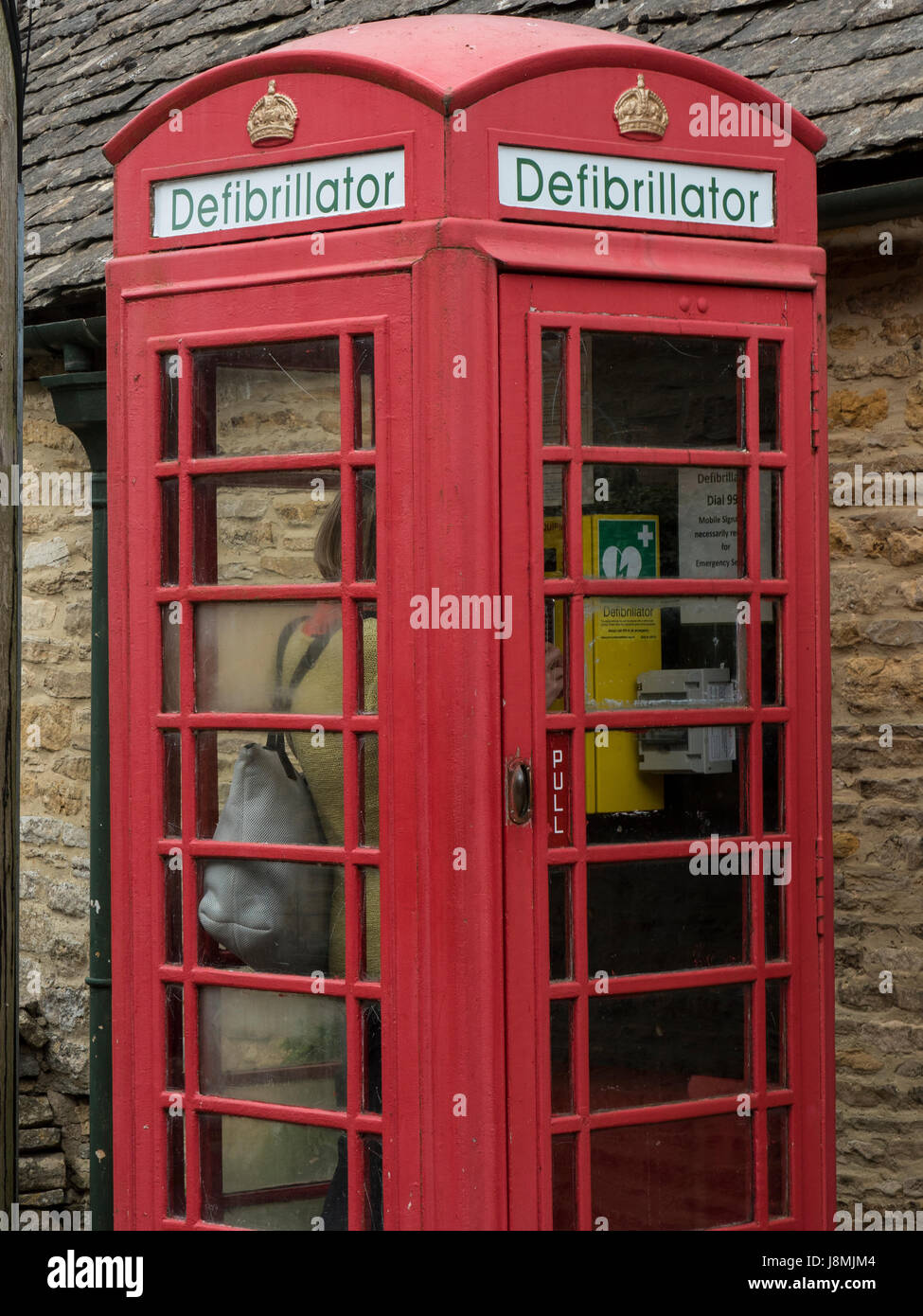 British telephone booth in Upper Slaughter, England are transformed into life saving Automatic Electric Defibrillator stations as pay phones disappear Stock Photo