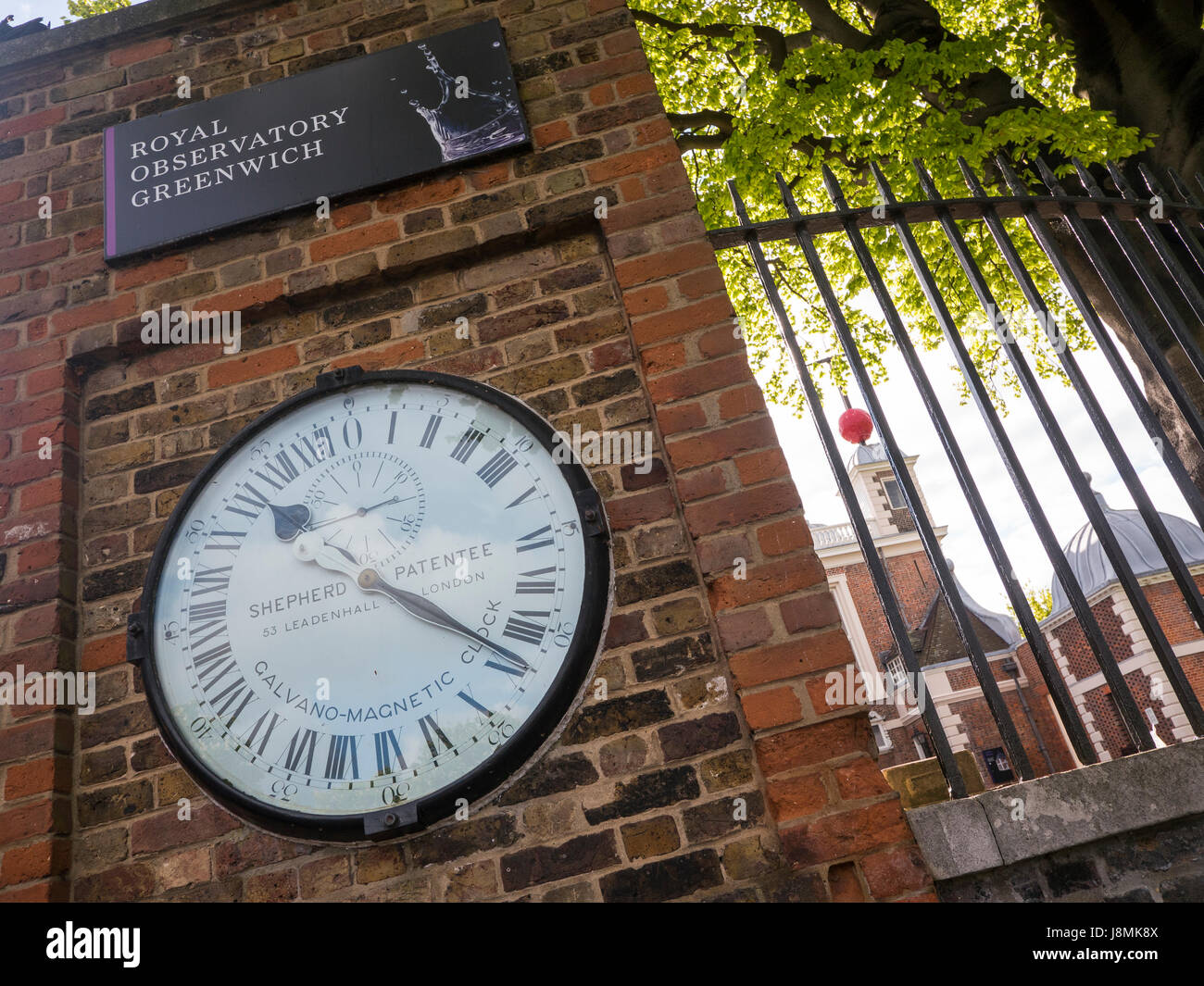 The Shepherd gate clock at the Royal Observatory in Greenwich, London, England, shows Greenwich Mean Time or GMT. Stock Photo
