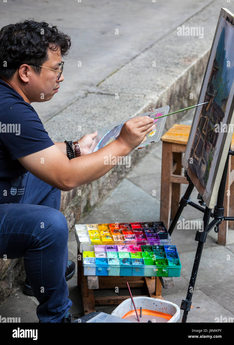 Linkeng, Zhejiang, China.  Artist Painting a Village Scene. Stock Photo