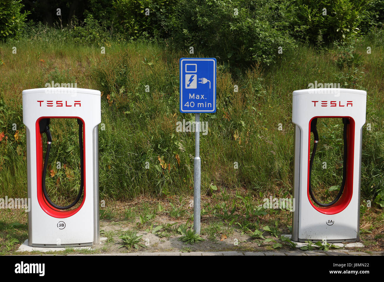 Tesla supercharger station in a hotel parking lot in the Netherlands