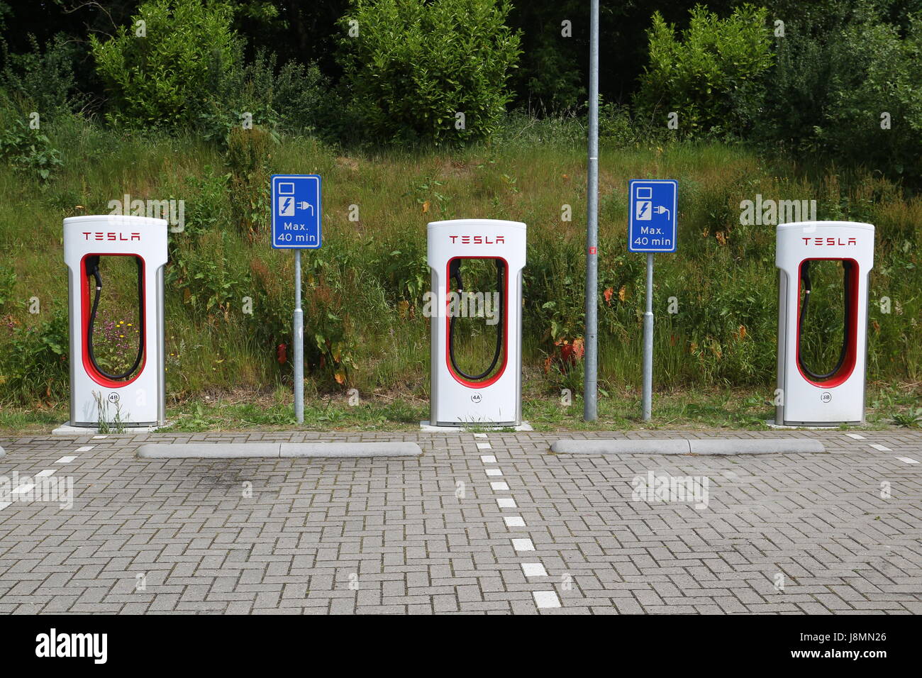 Tesla supercharger station in a hotel parking lot in the Netherlands
