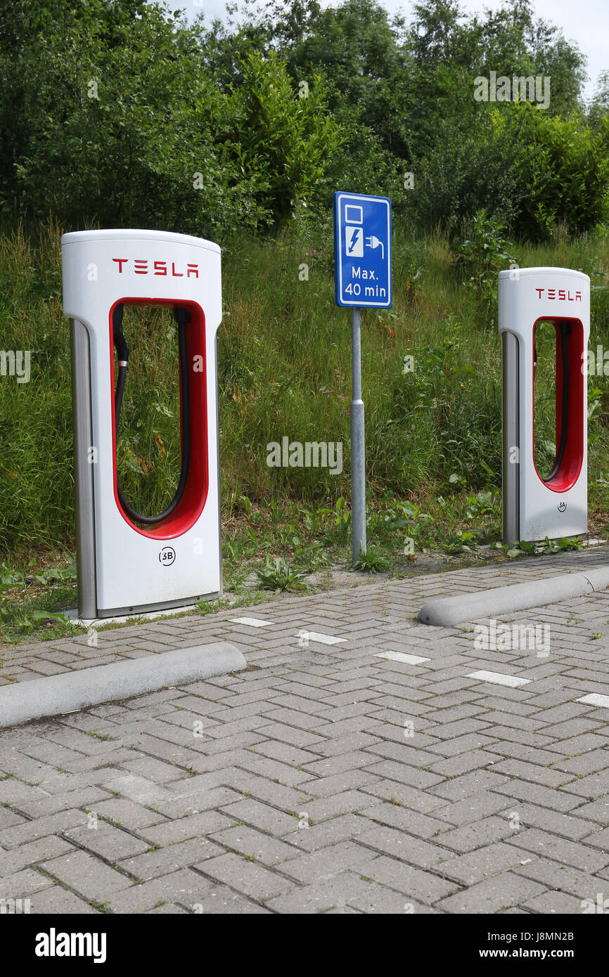 Tesla supercharger station in a hotel parking lot in the Netherlands