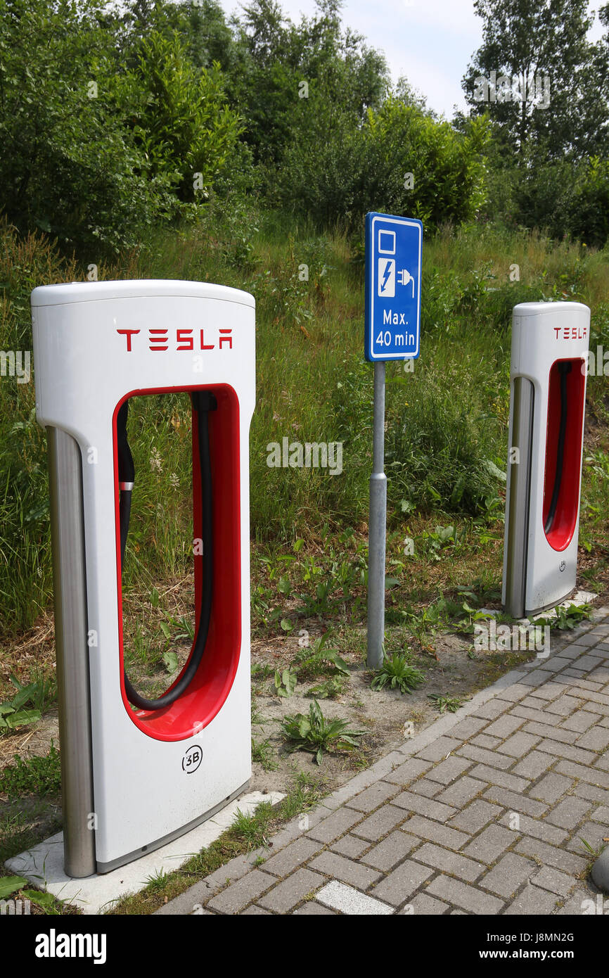 Tesla supercharger station in a hotel parking lot in the Netherlands