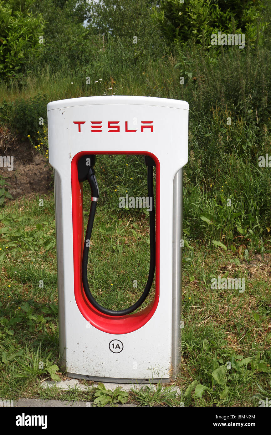 Tesla supercharger station in a hotel parking lot in the Netherlands