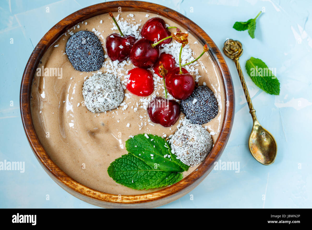 Chocolate smoothie bowl with cherry, mint and energy balls. Love for a  healthy vegan food concept Stock Photo - Alamy