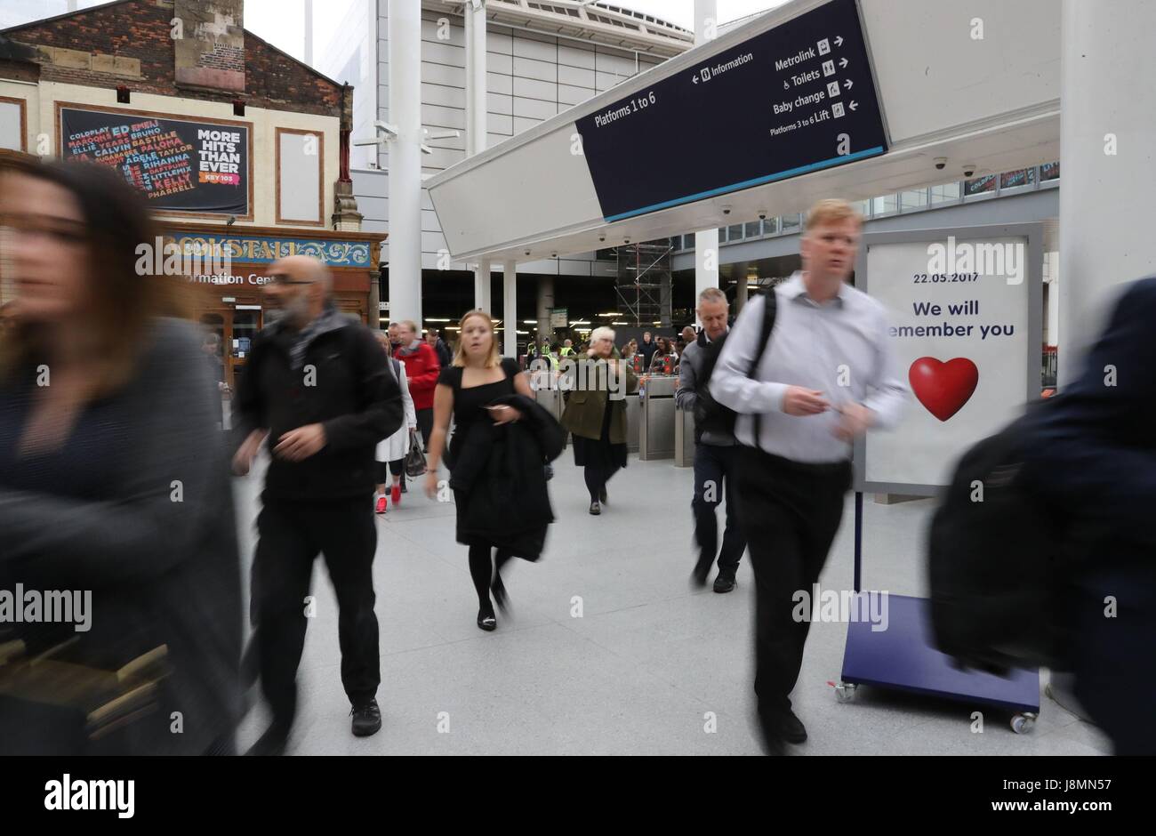 Commuters pass through Manchester Victoria railway station which has reopened for the first time since the terror attack on the adjacent Manchester Arena. Stock Photo