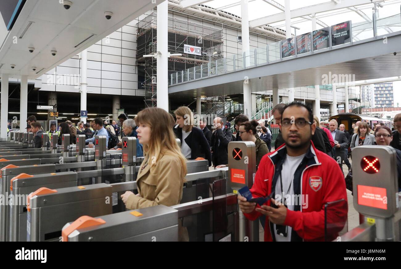 Commuters pass through Manchester Victoria railway station which has reopened for the first time since the terror attack on the adjacent Manchester Arena. Stock Photo