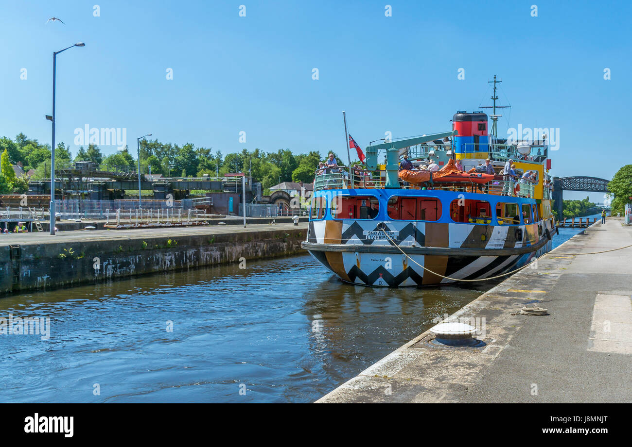 View of the pleasure cruiser 'Snowdrop' sailing along the Manchester Ship Canal and passing Latchford Locks in Warrington. Stock Photo