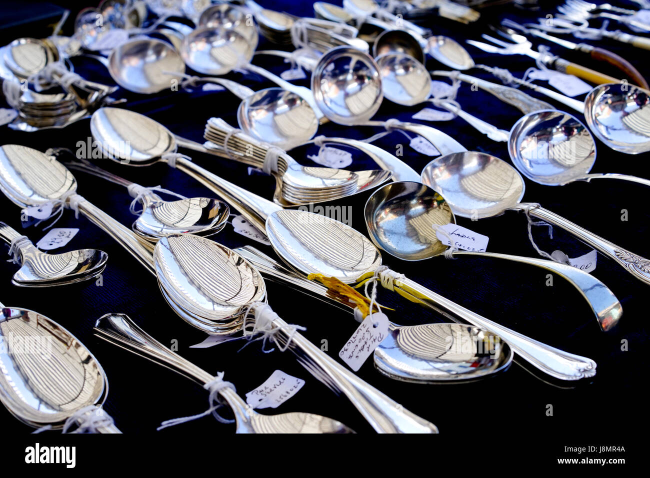 Silver spoons on a antique stall, England UK. Stock Photo