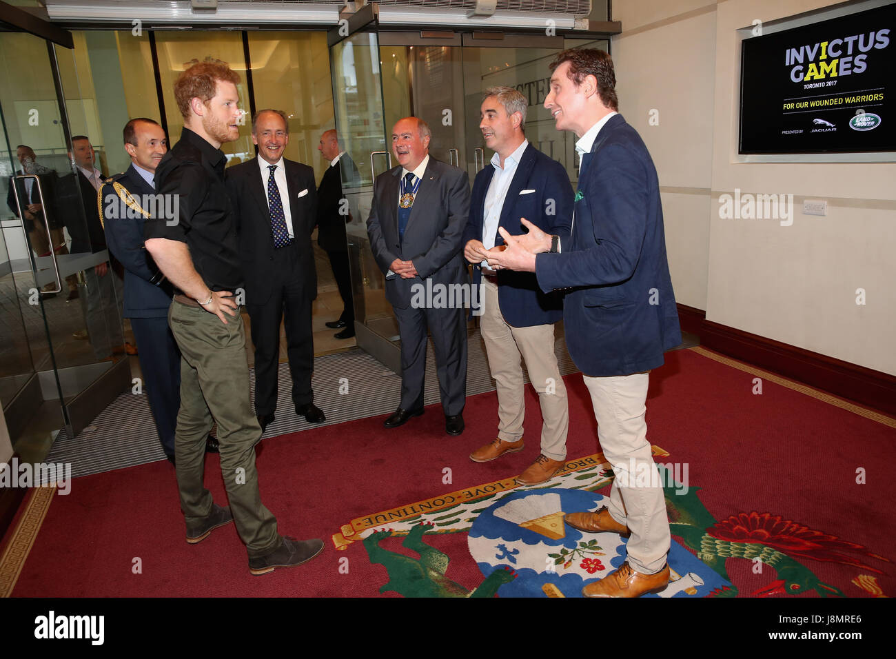 Prince Harry meets Giles (second right) and Nick (right) English of Bremont during the launch of the UK's Invictus Games team at Plaisterers Hall. Stock Photo