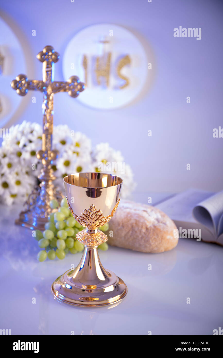 First Holy Communion. Catholic religion theme. Crucifix, Bible, bread  isolated on white table and white background Stock Photo - Alamy