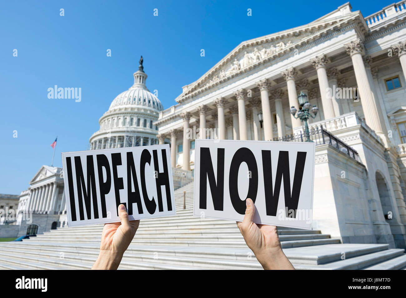 Hands of protesters holding signs on Capitol Hill demanding IMPEACH NOW referring to the president of the United States of America Stock Photo