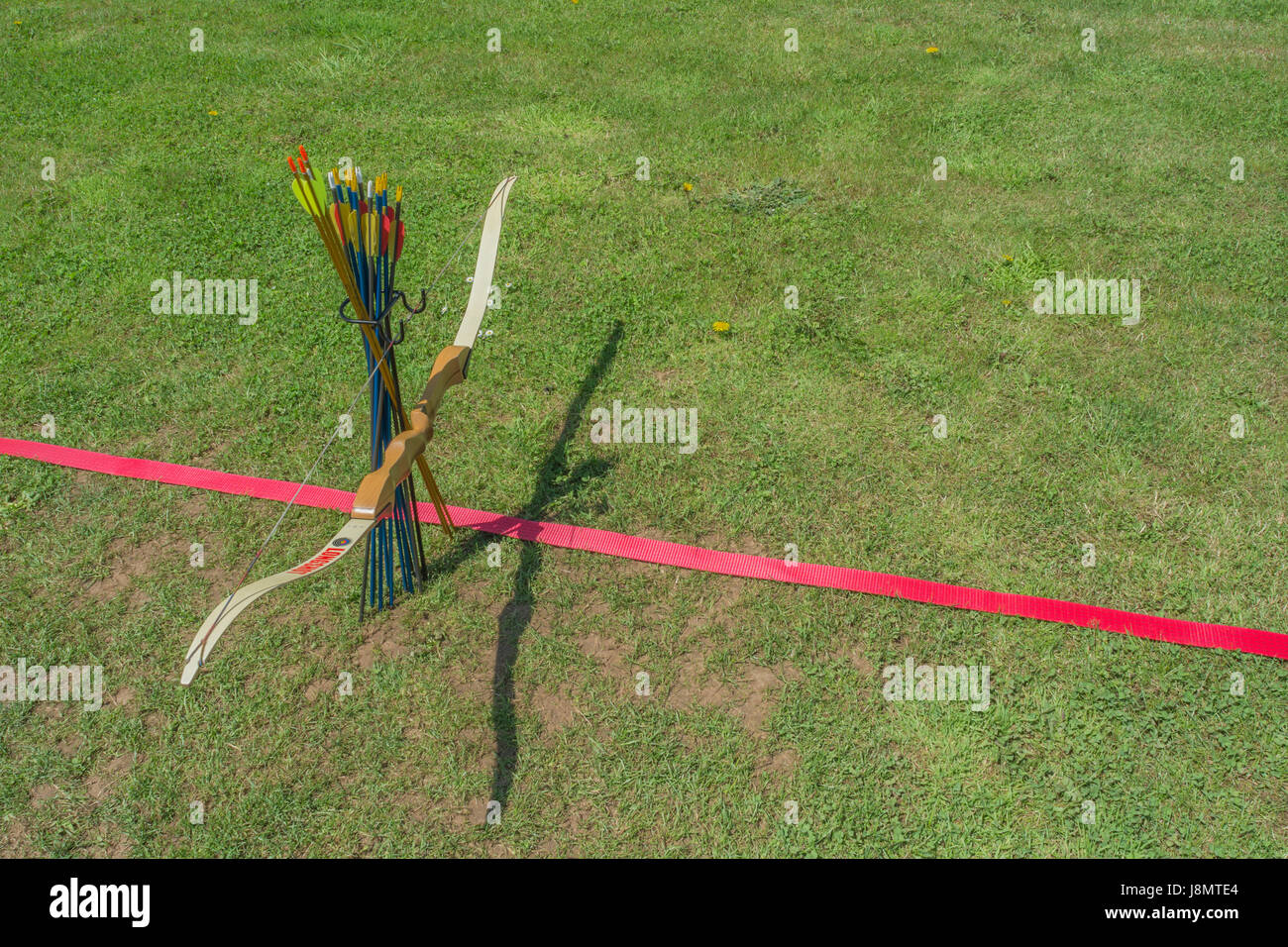 Sports target bow and arrows at the standing line on an archery range
