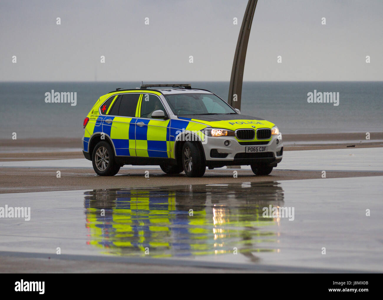 Blackpool, Fylde Coast, Lancashire, UK Weather. 29th May, 2017 Armed Police park on the Comedy Pavement their vehicles idciated with a red cross to the rear. Bank Holiday Washout with heavy and torrential rain forecast for the famous British Seaside resort. Further heavy downpours are expected with some risk of thunder as the resorts main outside attractions are all but deserted. Credit; MediaWorldImages/AlamyLiveNews Stock Photo