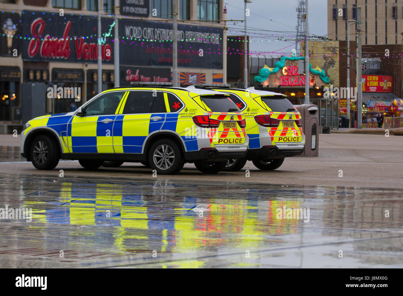 Blackpool, Fylde Coast, Lancashire, UK Weather. 29th May, 2017 Armed Police BMW cars park on the Comedy Pavement their vehicles indicated with a red cross or a star recognition sticker on the rear window.  Armed Response Police on red alert, law, security, people, crime, protection, gun, officer, uniform, cop, weapon, police are patrolling landmarks and town centres across the County. Stock Photo