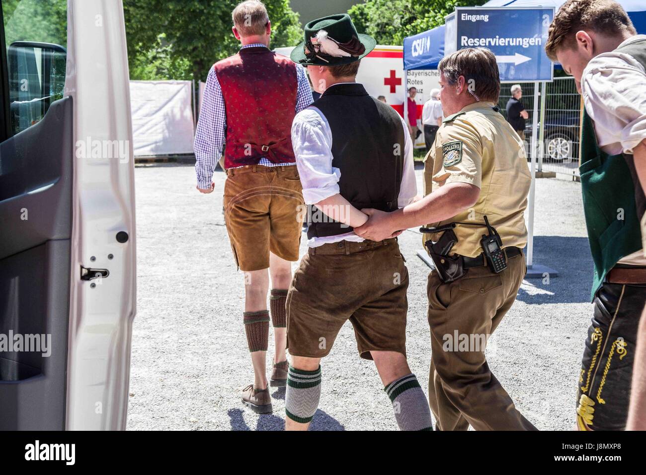 May 28, 2017 - MÃ¼Nchen, Bayern, Germany - Two from the extreme-right Identitaere Bewegung being led away after the disturbance they created. The Bundeskanzlerin (Chancellor) of Germany Angela Merkel (CDU) visited a beer tent in the Trudering district of Munich's east end, hosted by her Bavarian sister party, the CSU (Christian Socialist Union). The event was rescheduled from the 23rd due to the terror attack in Manchester. This visit was designed to be a more relaxed affair than previous ones, as Merkel's CDU and its branch in Bavaria, the right-conservative CSU, have had antagonistic Stock Photo