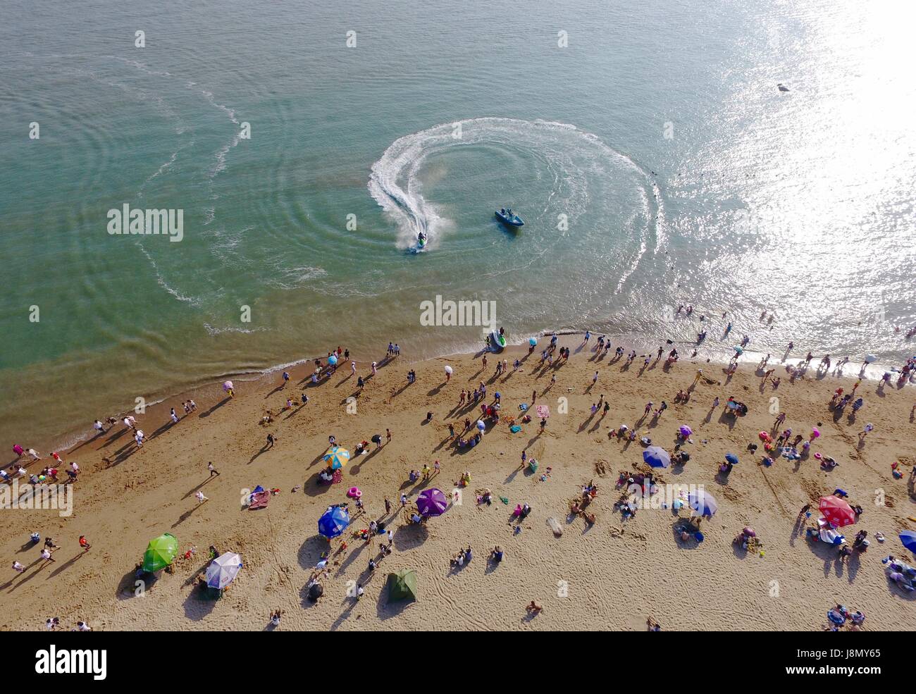 Xiamen, China's Fujian Province. 29th May, 2017. Tourists enjoy themselves on the beach in Xiamen City, southeast China's Fujian Province, May 29, 2017. People across China enjoy their three-day Dragon Boat Festival holiday from May 28 to 30. Credit: Jiang Kehong/Xinhua/Alamy Live News Stock Photo