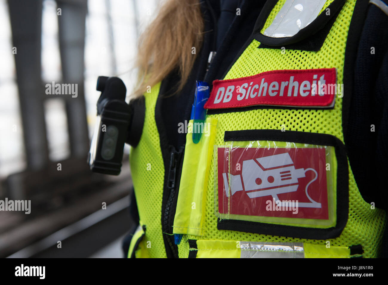 Berlin, Germany. 14th July, 2016. 'DB-Sicherheit' (lit. DB Security) and a video symbol on the vest of a member of Deutsche Bahn security staff at Alexanderplatz station in Berlin, Germany, 14 July 2016. Photo: Paul Zinken/dpa/Alamy Live News Stock Photo