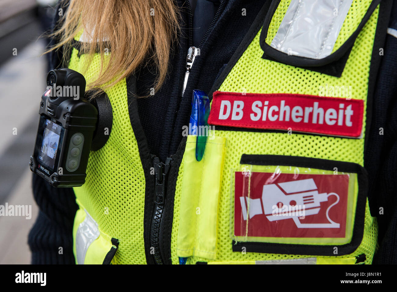 Berlin, Germany. 14th July, 2016. 'DB-Sicherheit' (lit. DB Security) and a video symbol on the vest of a member of Deutsche Bahn security staff at Alexanderplatz station in Berlin, Germany, 14 July 2016. Photo: Paul Zinken/dpa/Alamy Live News Stock Photo
