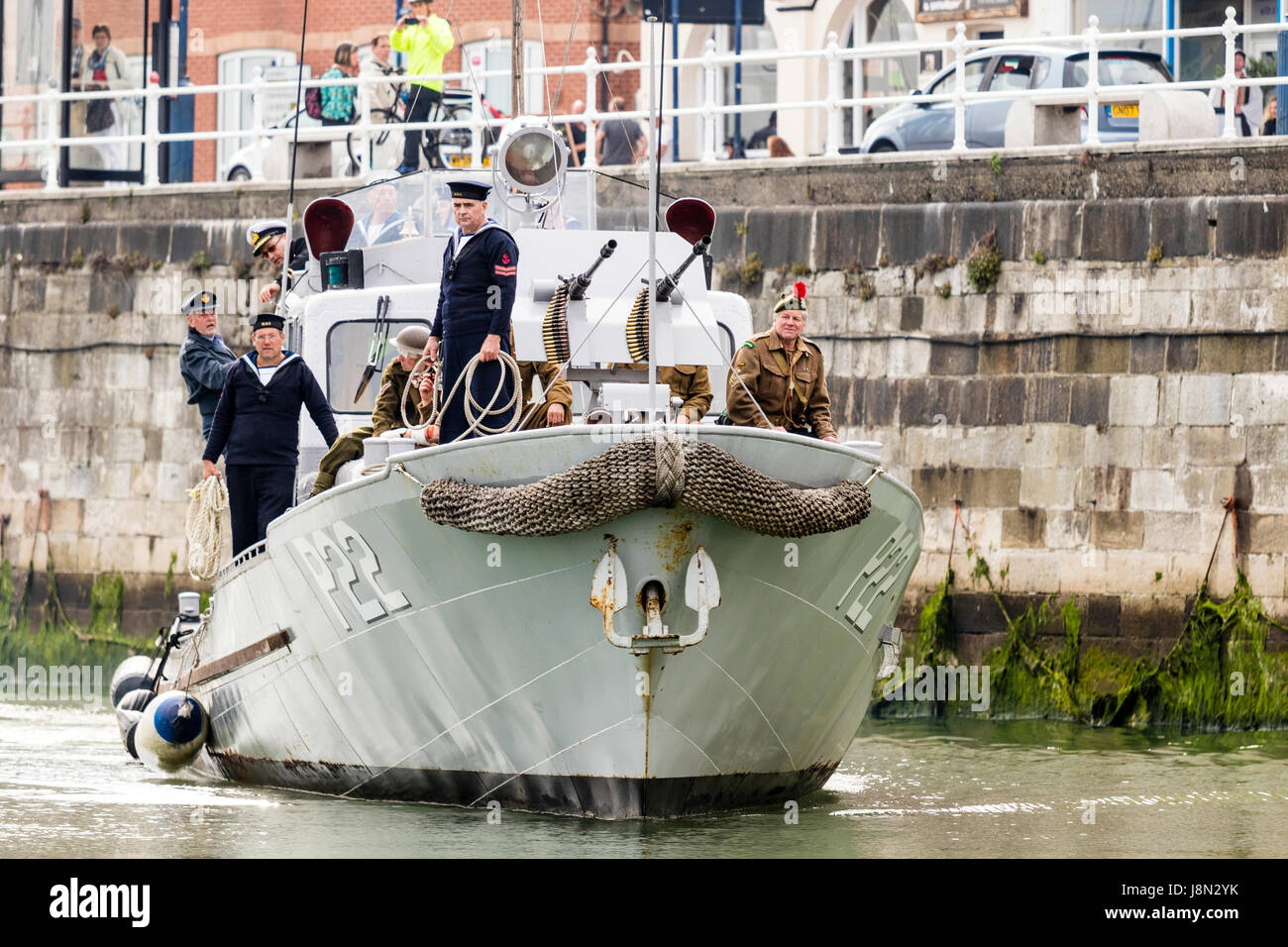 Dunkirk evacuation re-enactment at Ramsgate harbour in England. US type 21 patrol boat, the restored P22 approaching as it comes into dock at Ramsgate harbour with wounded and exhausted British soldiers on board. Stock Photo