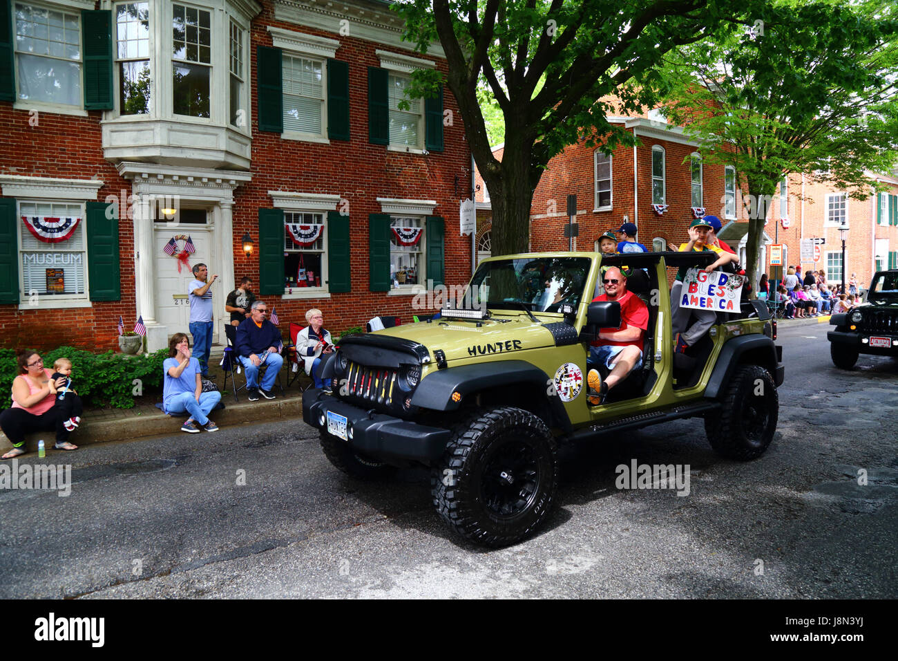 Westminster, Maryland, USA. 29th May, 2017. Schoolboys hold a handmade God Bless America placard and wave as they take part in parades for Memorial Day, a federal holiday in the United States for remembering those who died while serving in the country's armed forces. Credit: James Brunker/Alamy Live News Stock Photo