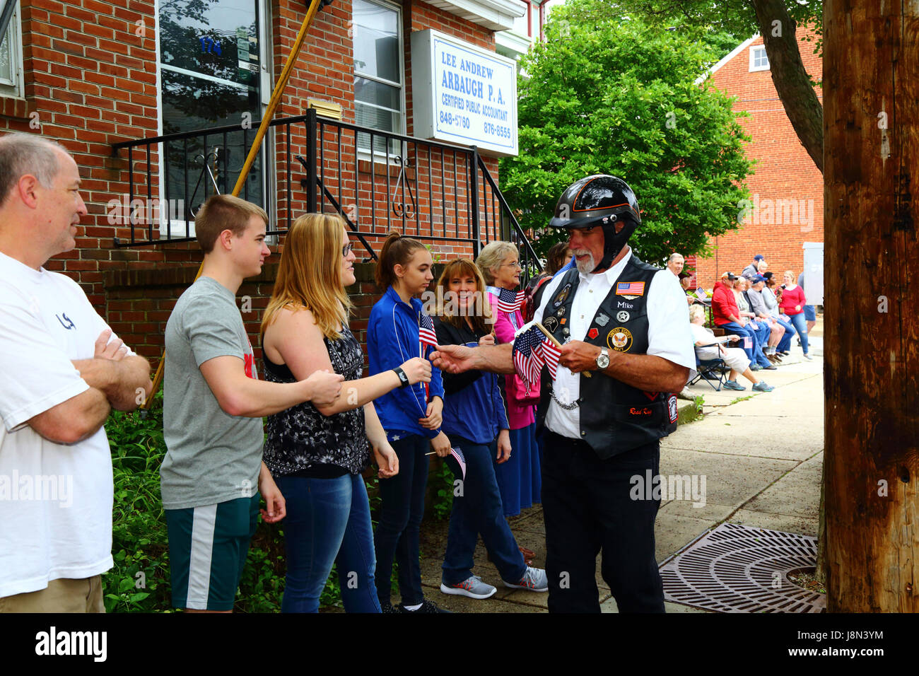 Westminster, Maryland, USA. 29th May, 2017. A former Navy serviceman hands out American flags to spectators at the start of parades for Memorial Day, a federal holiday in the United States for remembering those who died while serving in the country's armed forces. Credit: James Brunker/Alamy Live News Stock Photo