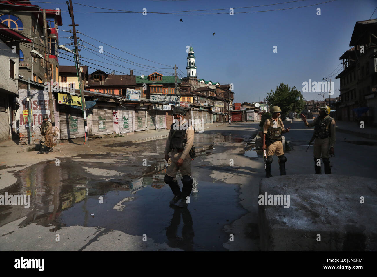 Srinagar, Kashmir. 30th May, 2017. Indian paramilitary troopers stand guard at a market during curfew-like restrictions in downtown Srinagar, summer capital of Kashmir, May 30, 2017. Curfew-like restrictions have been imposed in several areas of Srinagar to prevent protests and clashes. Credit: Javed Dar/Xinhua/Alamy Live News Stock Photo