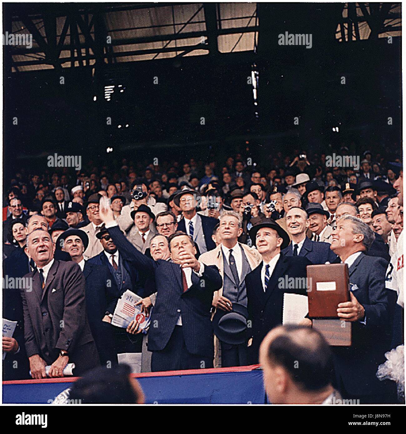 United States President John F. Kennedy throws out first ball at Griffith Stadium in Washington, D.C. on April 10,1961. (first row) Vice President Lyndon B. Johnson, President Kennedy, Dave Powers, Elwood Quesada. (second row) Secretary of Health, Education,and Welfare (HEW) Abraham Ribicoff, Assistant Press Secretary Andrew Hatcher, U.S. Senator Hubert Humphrey (Democrat of Minnesota),  U.S. Senator Everett Dirksen (Republican of Illinois) , U.S. Senator Mike Mansfield (Democrat of Montana). (third row) Lawrence O'Brien, spectators.  The Senators lost the game to the Chicago White Sox 4 - 3.. Stock Photo