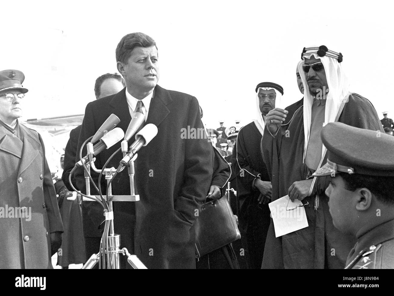 United States President John F. Kennedy welcomes a delegation led by King Saud bin Abdulaziz Al Saud of Saudi Arabia during a ceremony at Andrews Air Force Base, Maryland on February 13, 1962. Credit: Arnie Sachs/CNP /MediaPunch Stock Photo