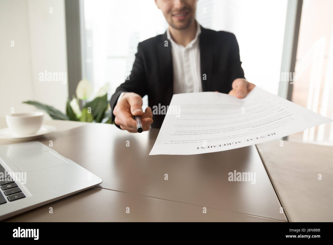 Realtor Reaching Out Pen And Rental Agreement To Clients Real Estate Stock Photo Alamy